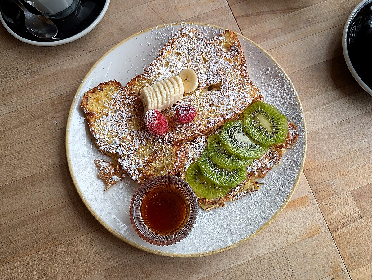 Golden pain perdu — thick slices of custard-soaked baguette French toast