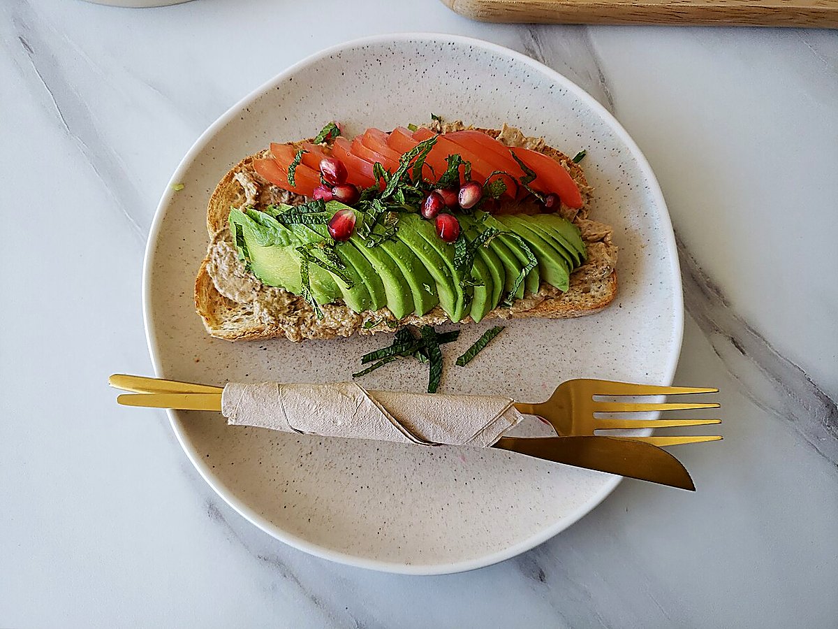 An avocado tartine on toasted country bread